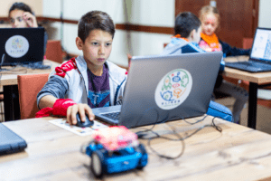 A boy is using a laptop on the table